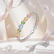 Multicolored gemstone bracelet on a white background with ribbons